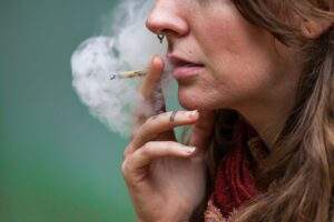 Woman smoking a cannabis cigarette.