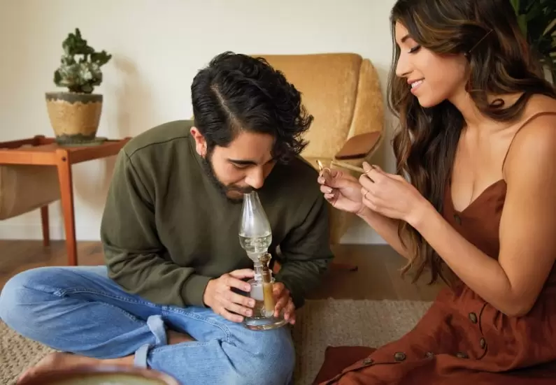 Group of friends playing fun cannabis smoking games during a relaxed session.